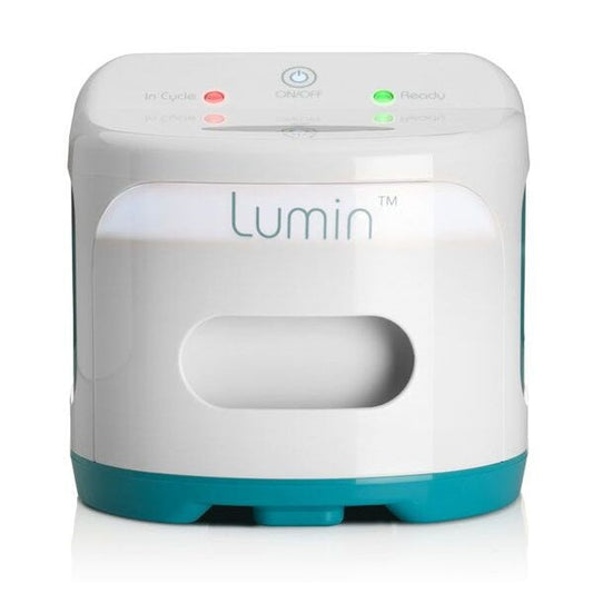 Photograph of the closed Lumin device from a straight-on front view, showing the control panel lights