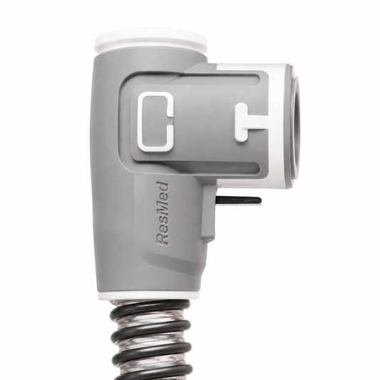 Close-up side view of the ResMed ClimateLineAir machine cuff elbow, showing the ResMed logo and C and T port markings