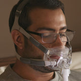 Man wearing the Amara View full face mask with glasses on, showing the clear sight line above the cushion