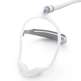 The DreamWear frame with a CPAP hose connected at the crown and the fabric headgear strap fitted