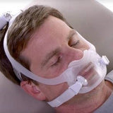 Photograph of a man wearing the DreamWear Full Face mask while resting with his eyes closed