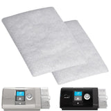 Two flat white standard CPAP filter pads shown above a ResMed AirCurve 10 and a ResMed AirSense 10