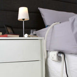 AirMini mounted at the side of a bed beside a nightstand, tube running up to the pillow
