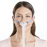 Photograph of a woman wearing the AirFit P10 For Her, seen from the front with the pillows in place