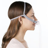 Side profile photograph of a woman wearing the AirFit P10 For Her nasal pillow mask