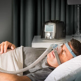 Man asleep on his side wearing the Fisher and Paykel Eson 2 nasal CPAP mask
