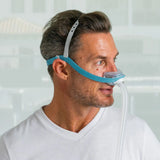 Man wearing the Fisher and Paykel Evora nasal CPAP mask, showing its minimal under-nose cushion and CapFit headgear
