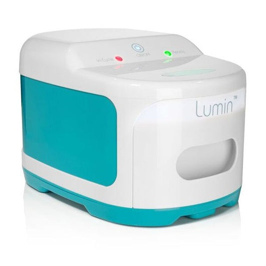 Photograph of the closed Lumin device from a three-quarter angle, showing the control panel and handle