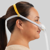 Woman wearing the Fisher and Paykel Solo nasal mask in profile with her sightline left clear