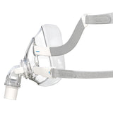 Side profile of ResMed AirFit F20 full face CPAP mask showing elbow connection, headgear straps, and flexible frame