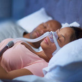 Woman wearing the ResMed AirFit N20 in profile, showing how little of the mask touches her face