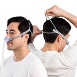 Man adjusting ResMed AirFit N30 CPAP mask headgear for personalized fit