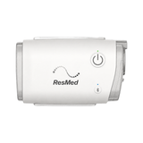 ResMed AirMini travel CPAP machine on a white background, power button and Bluetooth indicator visible