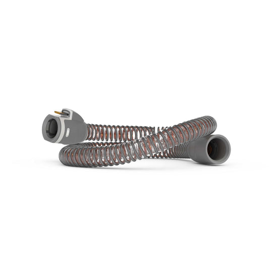 ResMed ClimateLineAir 11 heated tube coiled on white, flat gold-pin connector visible at the machine end