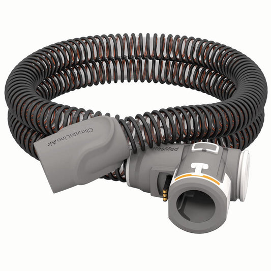 ResMed ClimateLineAir heated tube coiled on white, three quarter view of the machine end connector