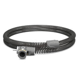 ResMed ClimateLineAir Oxy heated tube coiled on white, three quarter view of the oxygen inlet and machine cuff