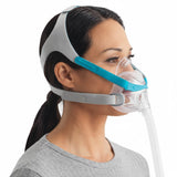 Woman wearing the Evora Full Face mask, seen from the side with the short tube running forward