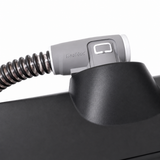 Close-up of the ResMed ClimateLineAir machine-end connector seated in the AirSense 10 port
