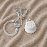 The Transcend Micro on the PowerAway battery, sold separately, beside a hose and nasal pillow mask