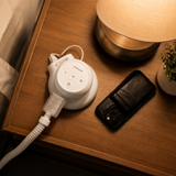 Lifestyle photograph of an original Transcend Micro on a bedroom nightstand with the muffler and hose connected