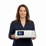 A woman holding the ResMed AirCurve 11 VAuto, showing how compact the machine is in two hands